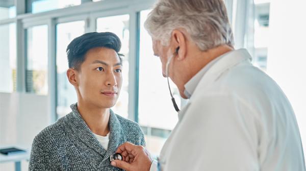 physician checking man's heart