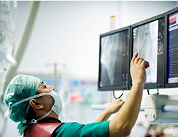 Physician checking xrays on a computer monitor