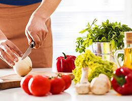 Chef cutting vegetables in a kitchen