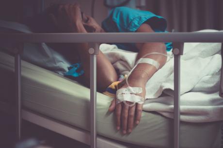 sick woman lying in hospital bed