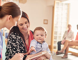 Women with her baby seeing a nurse